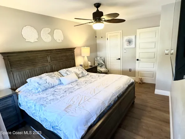 a large bedroom with a bed and a chandelier