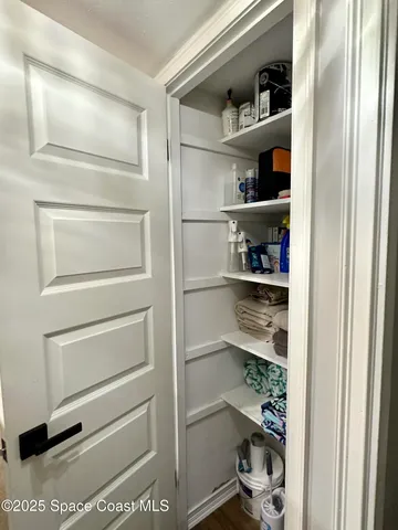 a view of walk in closet with empty racks