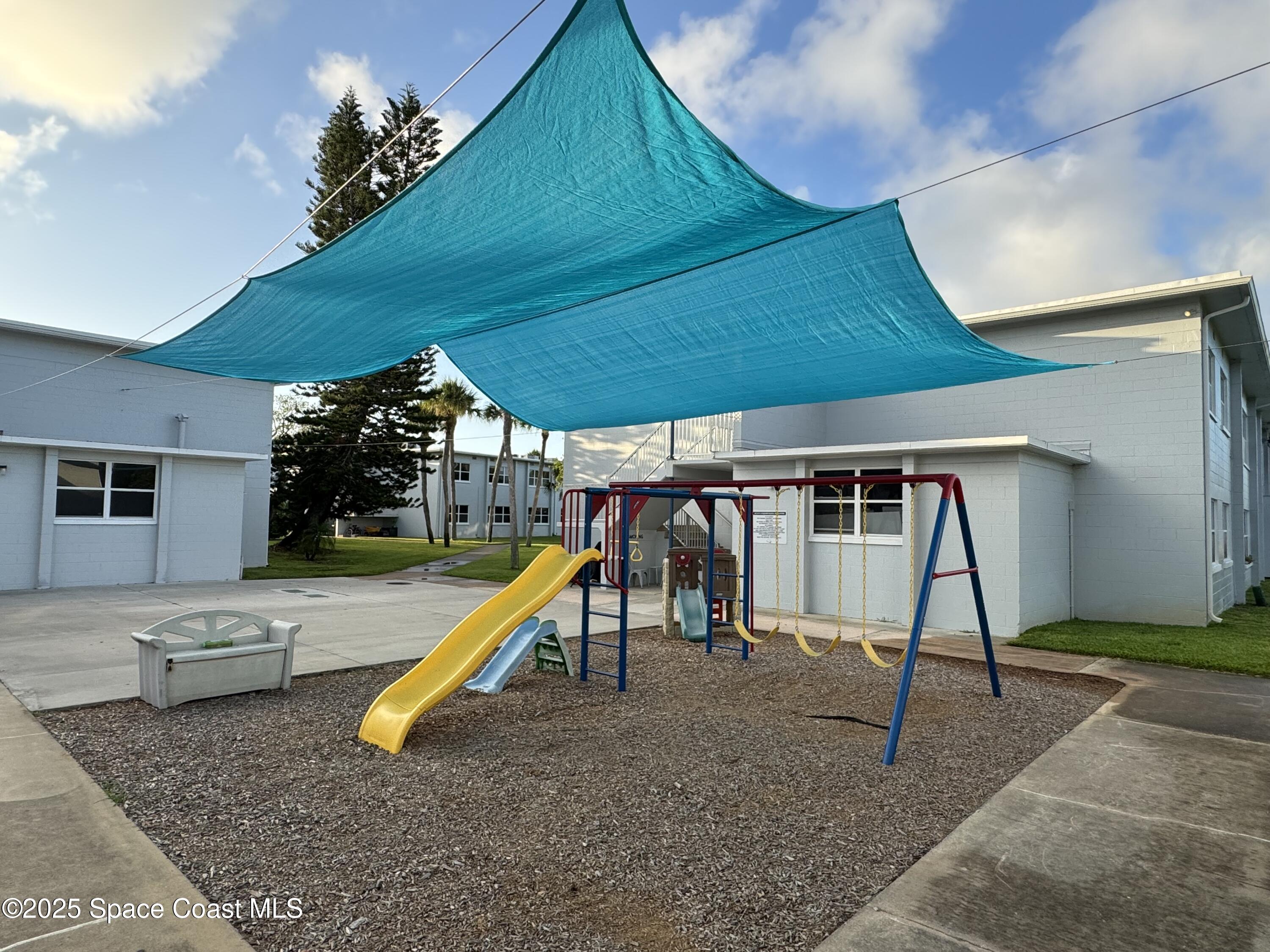 215 Buccaneer Avenue, Unit 3201 Merritt Island, FL 32952 - Photo 19 of 29 a view of a hall with a slide
