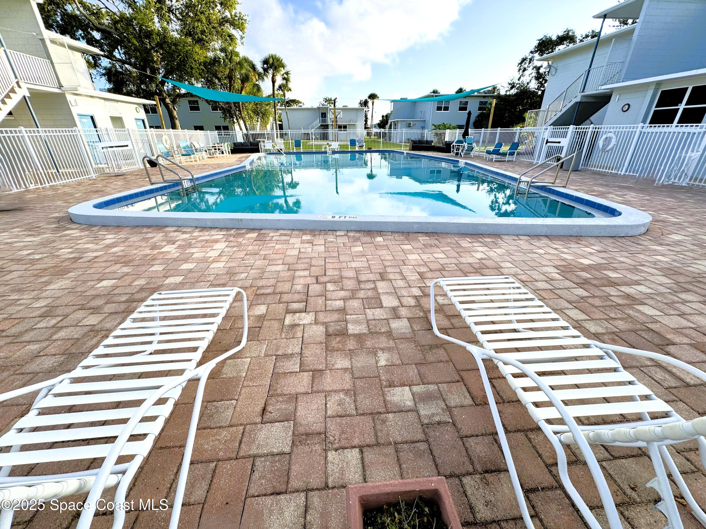 215 Buccaneer Avenue, Unit 3201 Merritt Island, FL 32952 - Photo 20 of 29 a view of a swimming pool with a patio