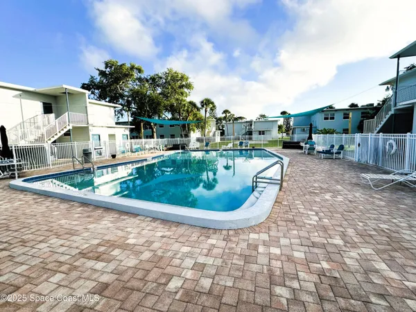 a view of a swimming pool with a yard