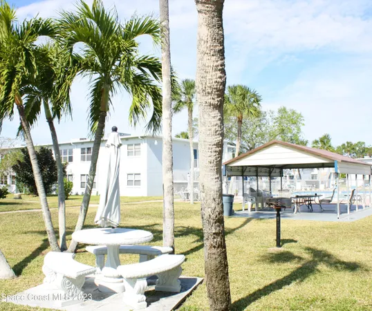 a swimming pool with outdoor seating and yard