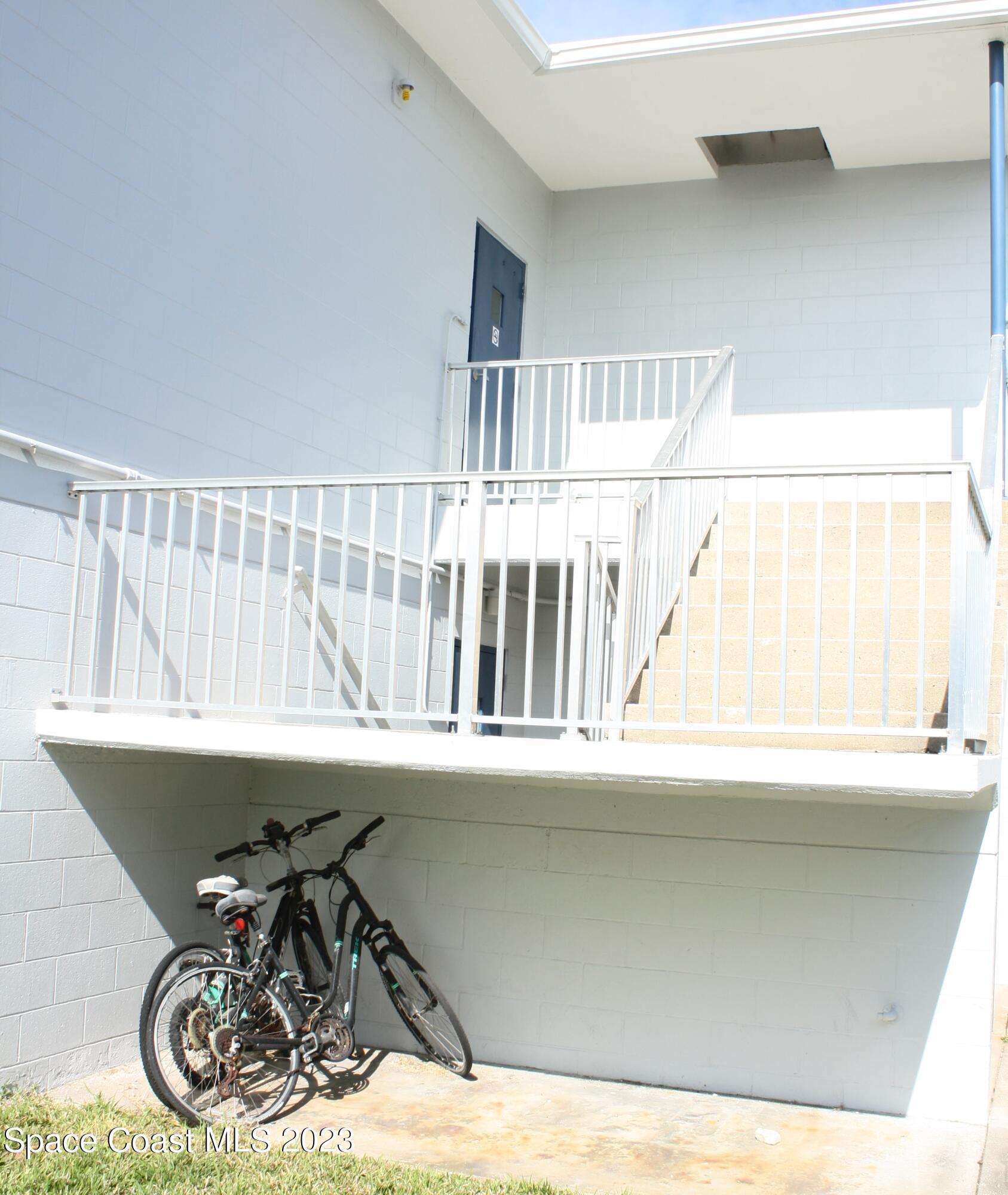 215 Buccaneer Avenue, Unit 3201 Merritt Island, FL 32952 - Photo 25 of 29 a view of a chair and table in a white house