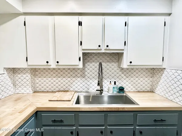 a kitchen with a sink and cabinets