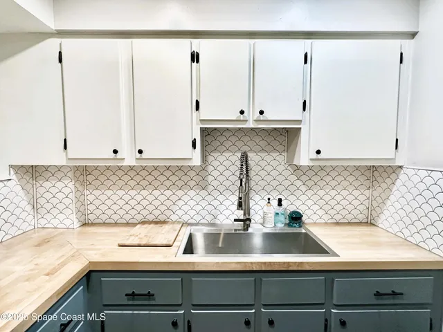 a kitchen with a sink and cabinets
