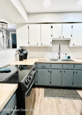 a kitchen with a sink stove and cabinets