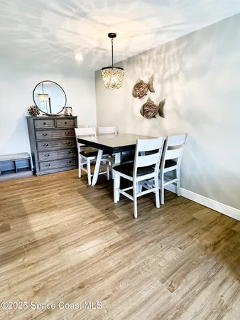 a view of a room with furniture and wooden floor