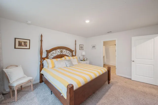 a bedroom with a bed and a chair