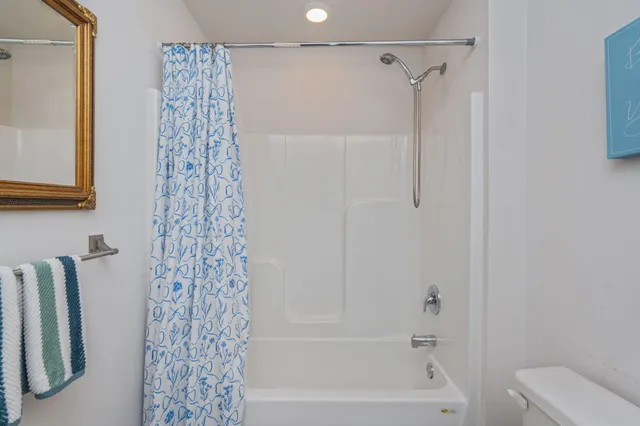 a bathroom with a shower curtain and a bathtub