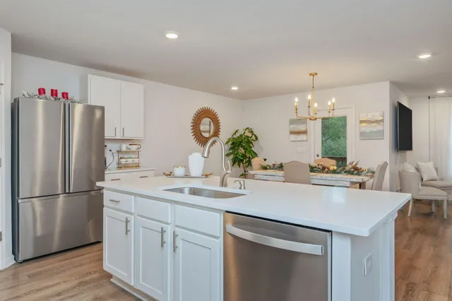a kitchen with a sink and refrigerator