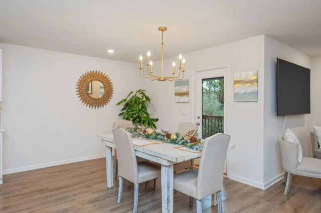 a view of a dining room with furniture wooden floor and chandelier