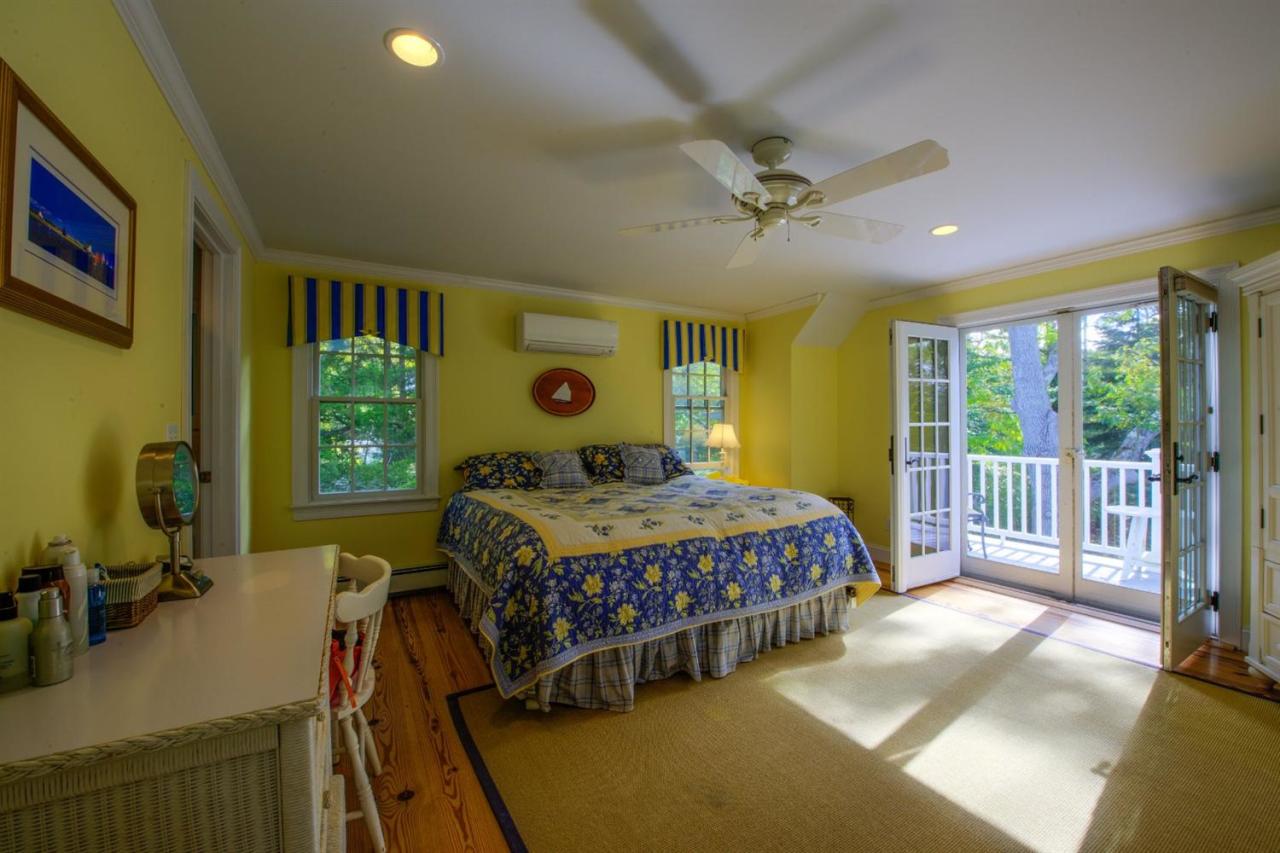 65 Shell Lane Cotuit, MA 02635 - Photo 15 of 32 a bedroom with a bed a dresser with wooden floor