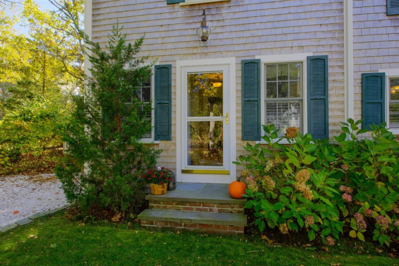 65 Shell Lane Cotuit, MA 02635 - Photo 3 of 32 a view of a house with potted plants and a bench