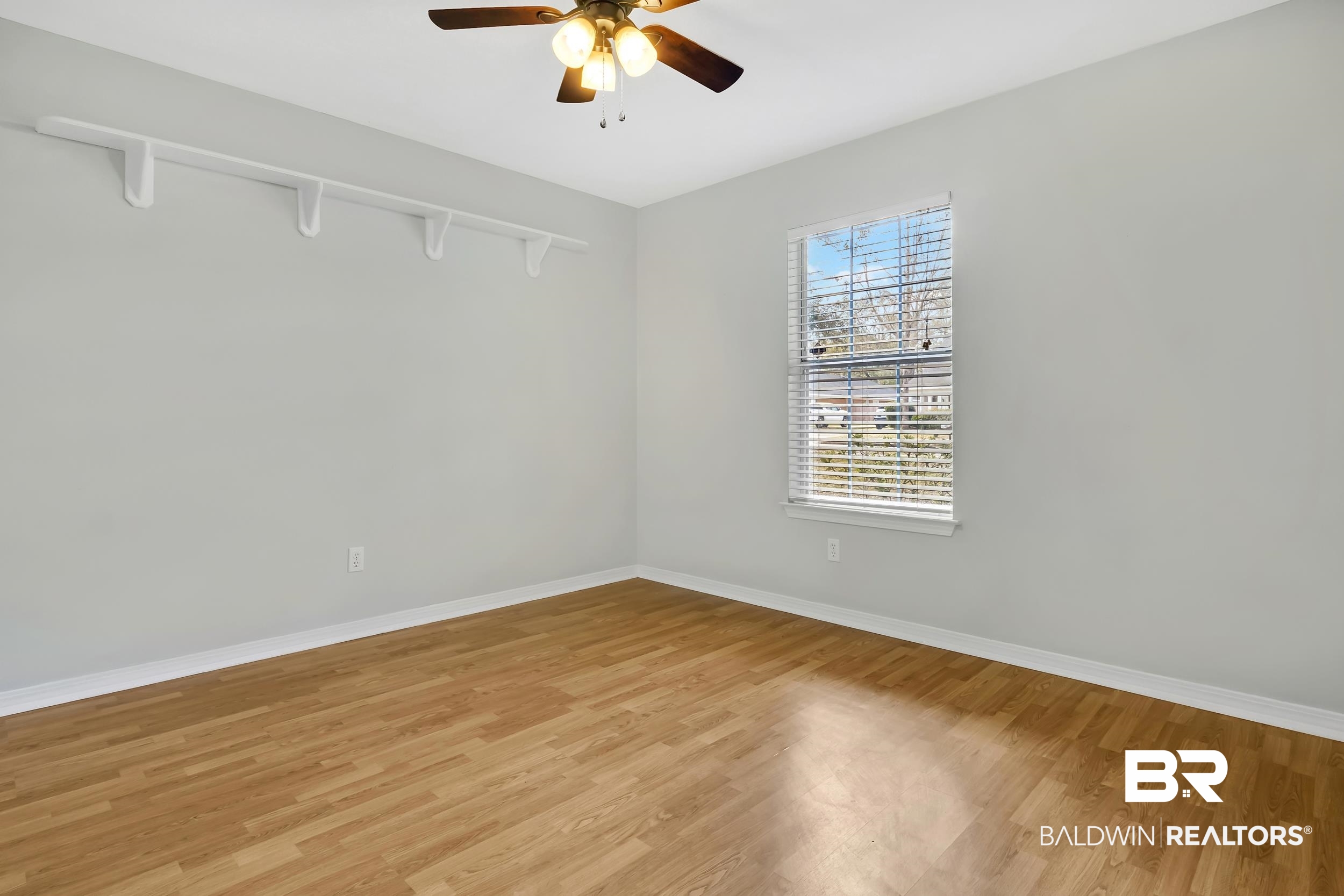 6616 Conde Court Mobile, AL 36695 - Photo 21 of 27 Empty room with baseboards, light wood-style floors, and a ceiling fan