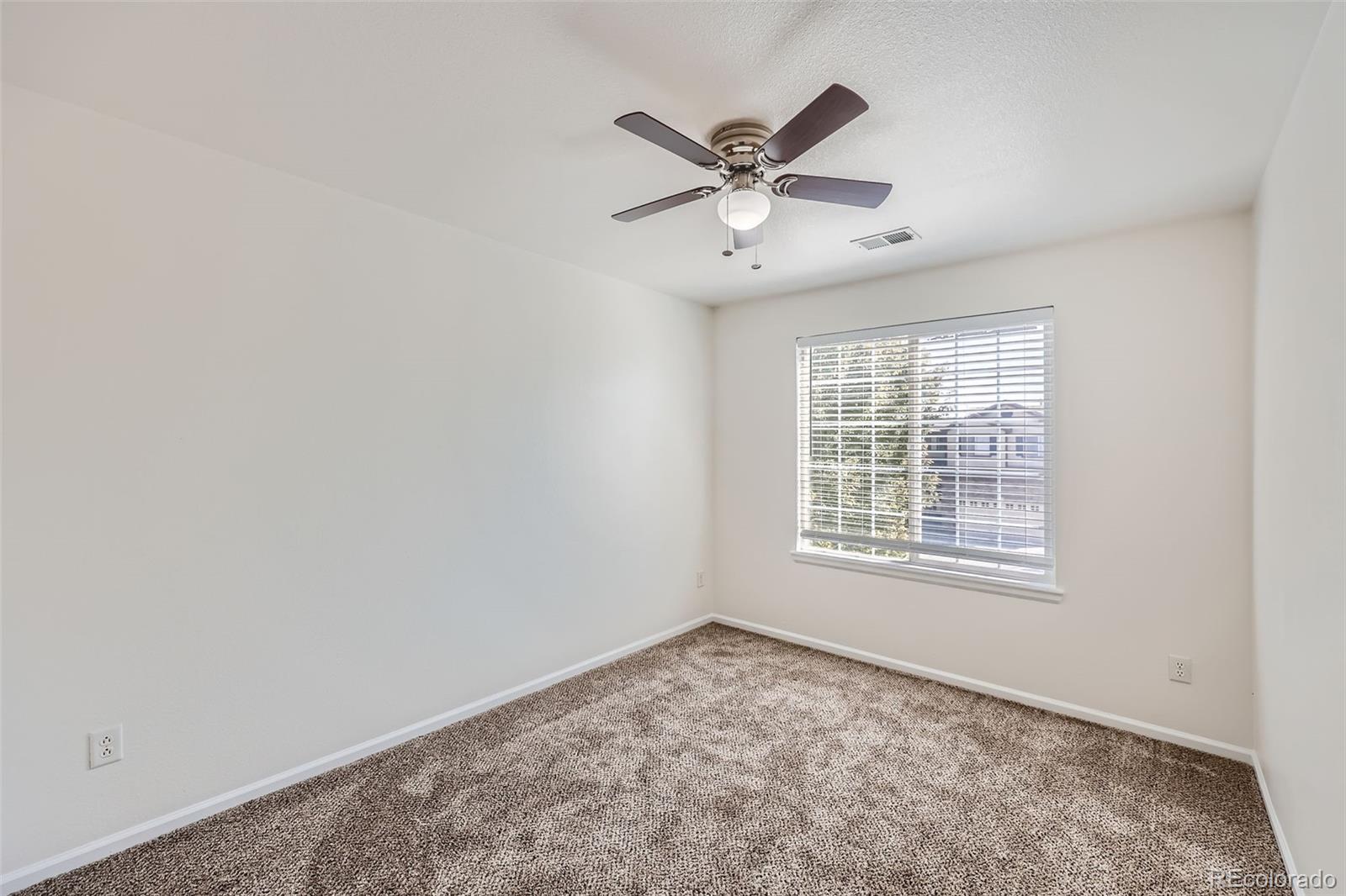 10562 Tracewood Circle Highlands Ranch, CO 80130 - Photo 19 of 28 an empty room with a window