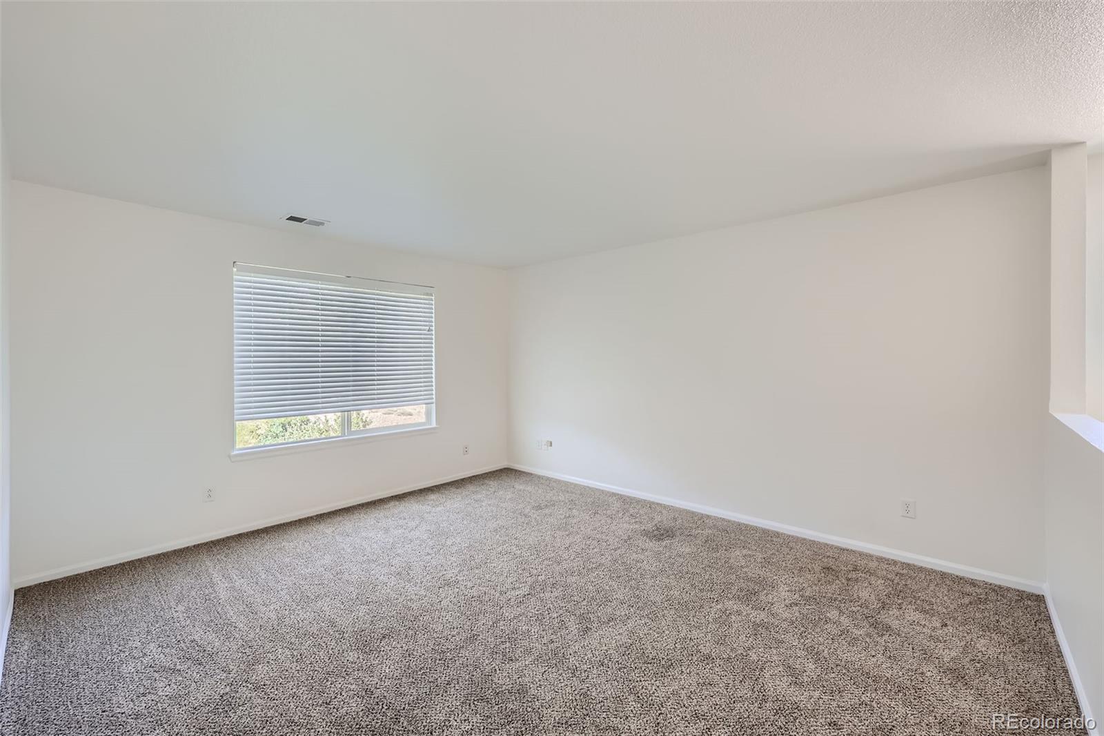 10562 Tracewood Circle Highlands Ranch, CO 80130 - Photo 24 of 28 a view of an empty room with a window