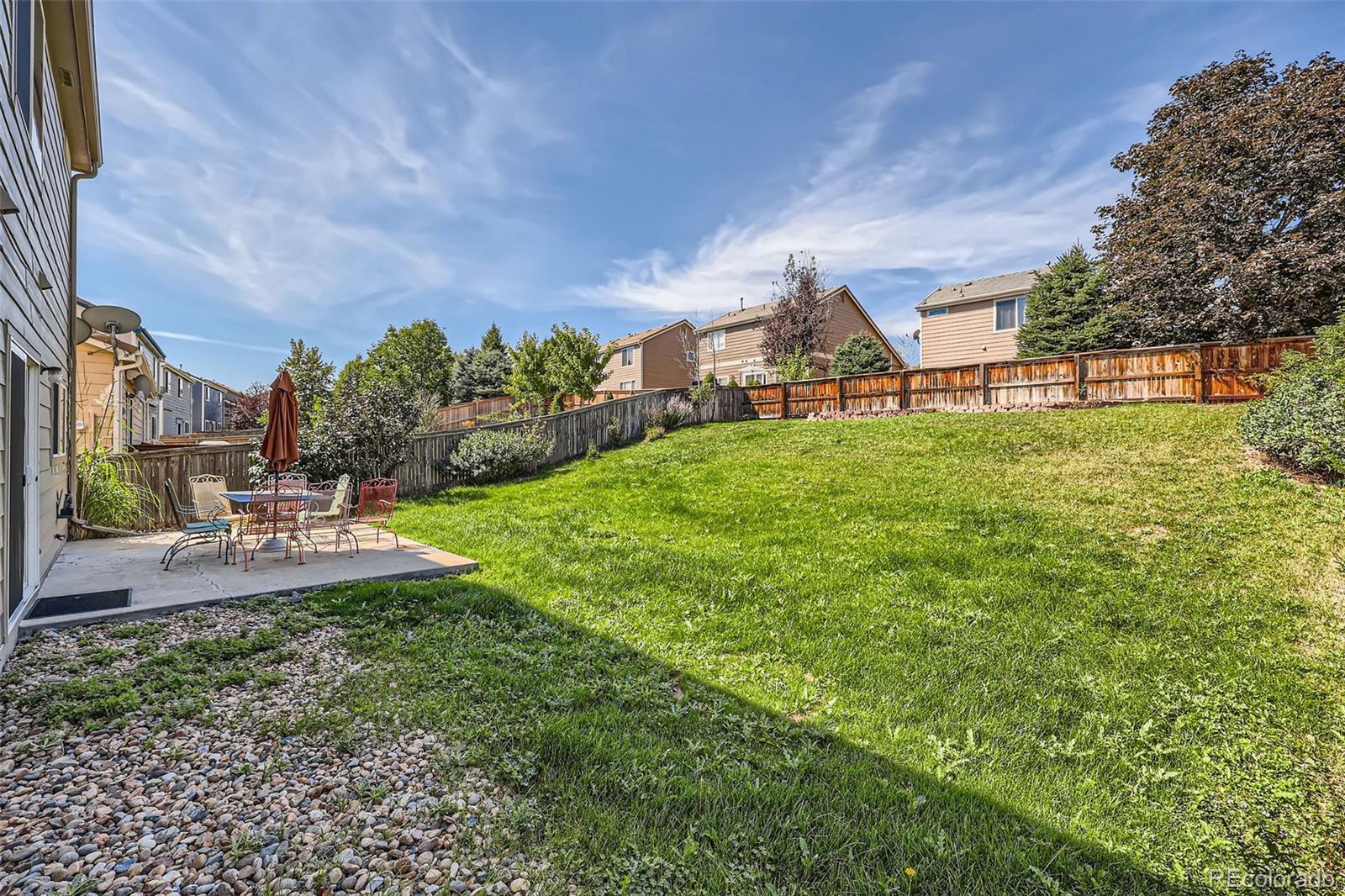 10562 Tracewood Circle Highlands Ranch, CO 80130 - Photo 26 of 28 a view of a house with a yard porch and sitting area