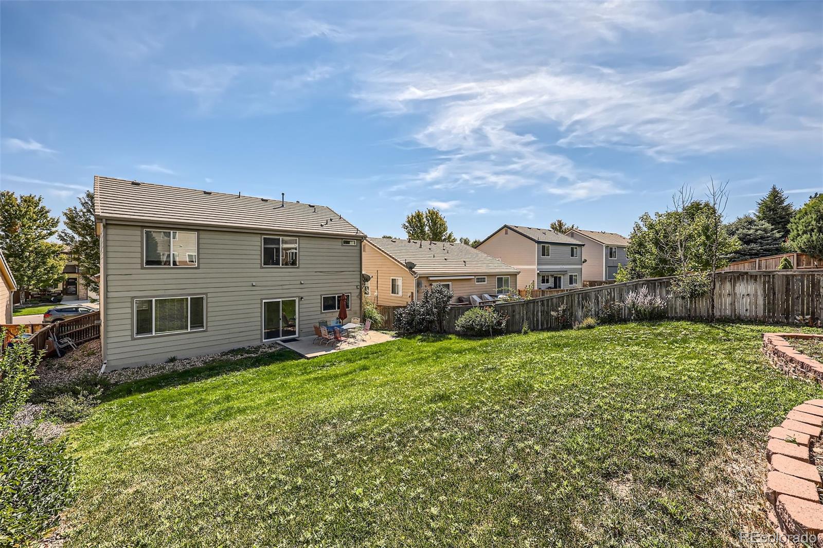 10562 Tracewood Circle Highlands Ranch, CO 80130 - Photo 27 of 28 a front view of a house with garden