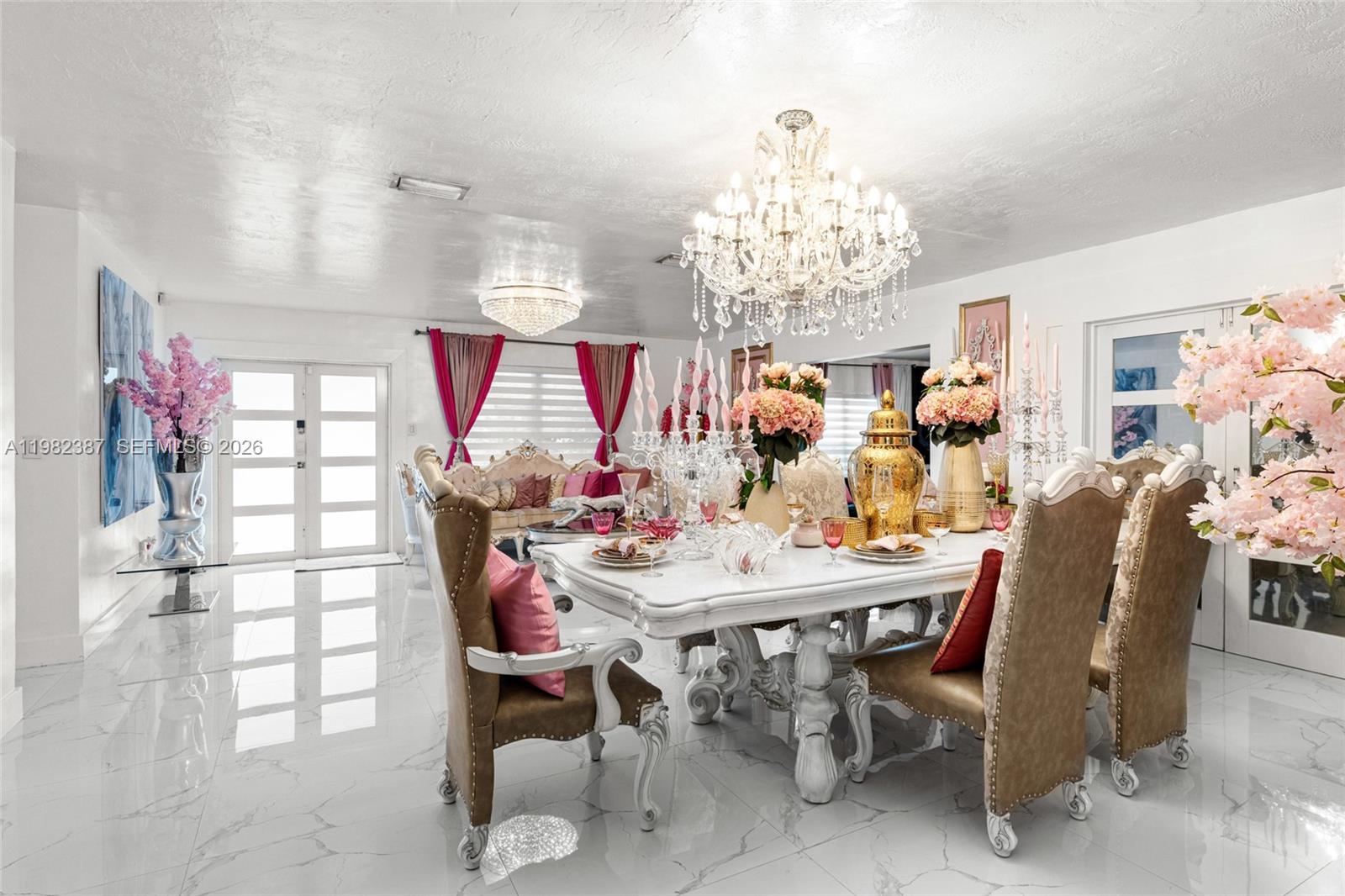 12721 Southwest 47th Street Miami, FL 33175 - Photo 11 of 47 a view of a dining room with furniture and chandelier