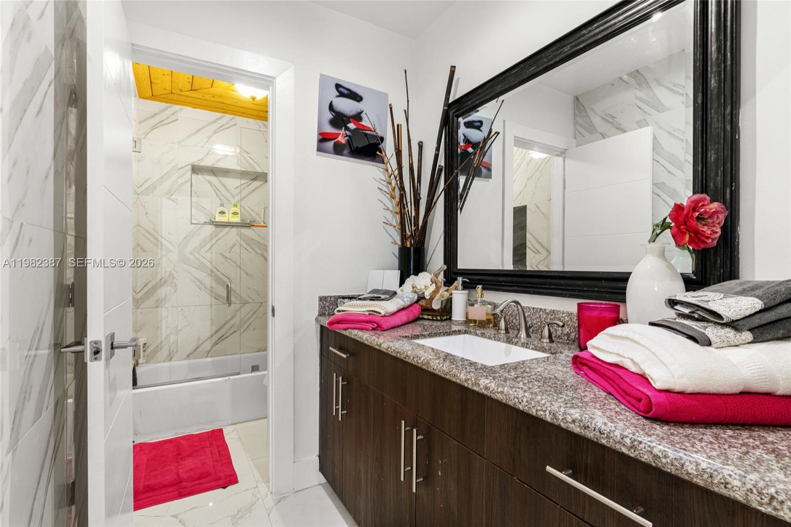 12721 Southwest 47th Street Miami, FL 33175 - Photo 18 of 47 a bathroom with a granite countertop tub sink and mirror