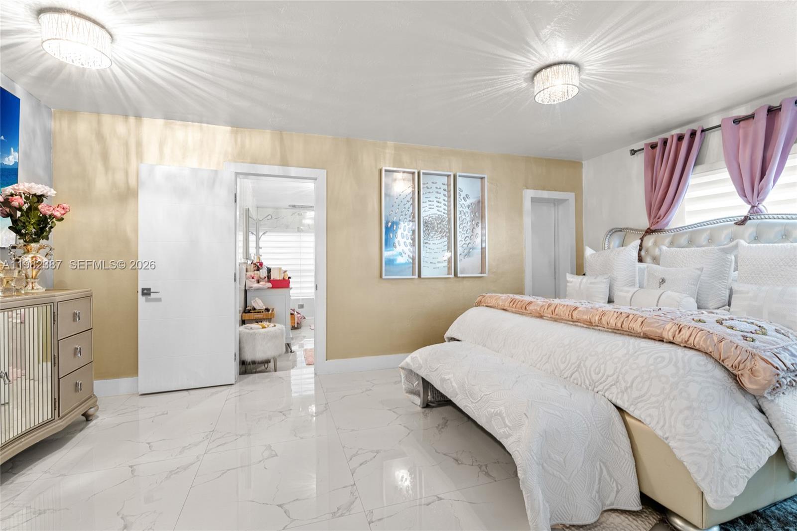 12721 Southwest 47th Street Miami, FL 33175 - Photo 19 of 47 a bedroom with a bed and a chandelier