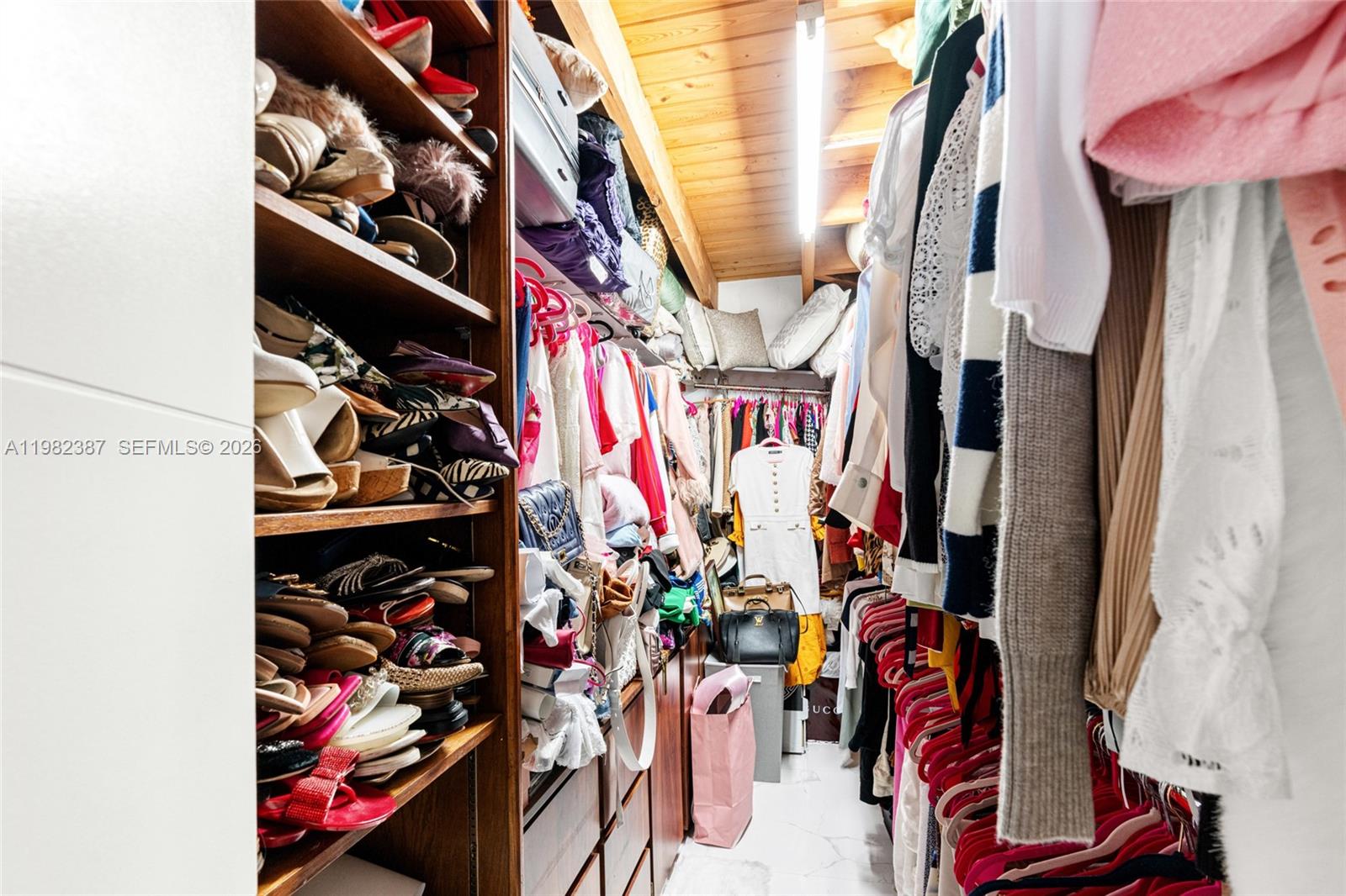 12721 Southwest 47th Street Miami, FL 33175 - Photo 23 of 47 a view of walk in closet with clothes