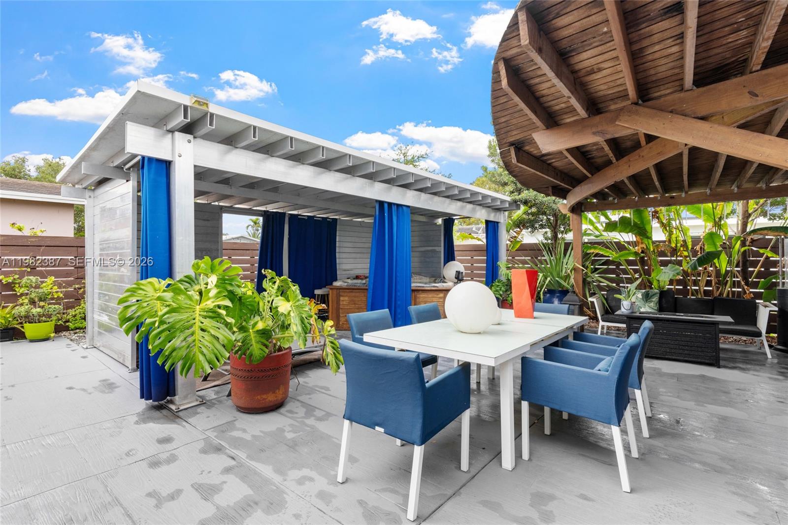 12721 Southwest 47th Street Miami, FL 33175 - Photo 34 of 47 a view of a patio with a table and chairs and potted plants