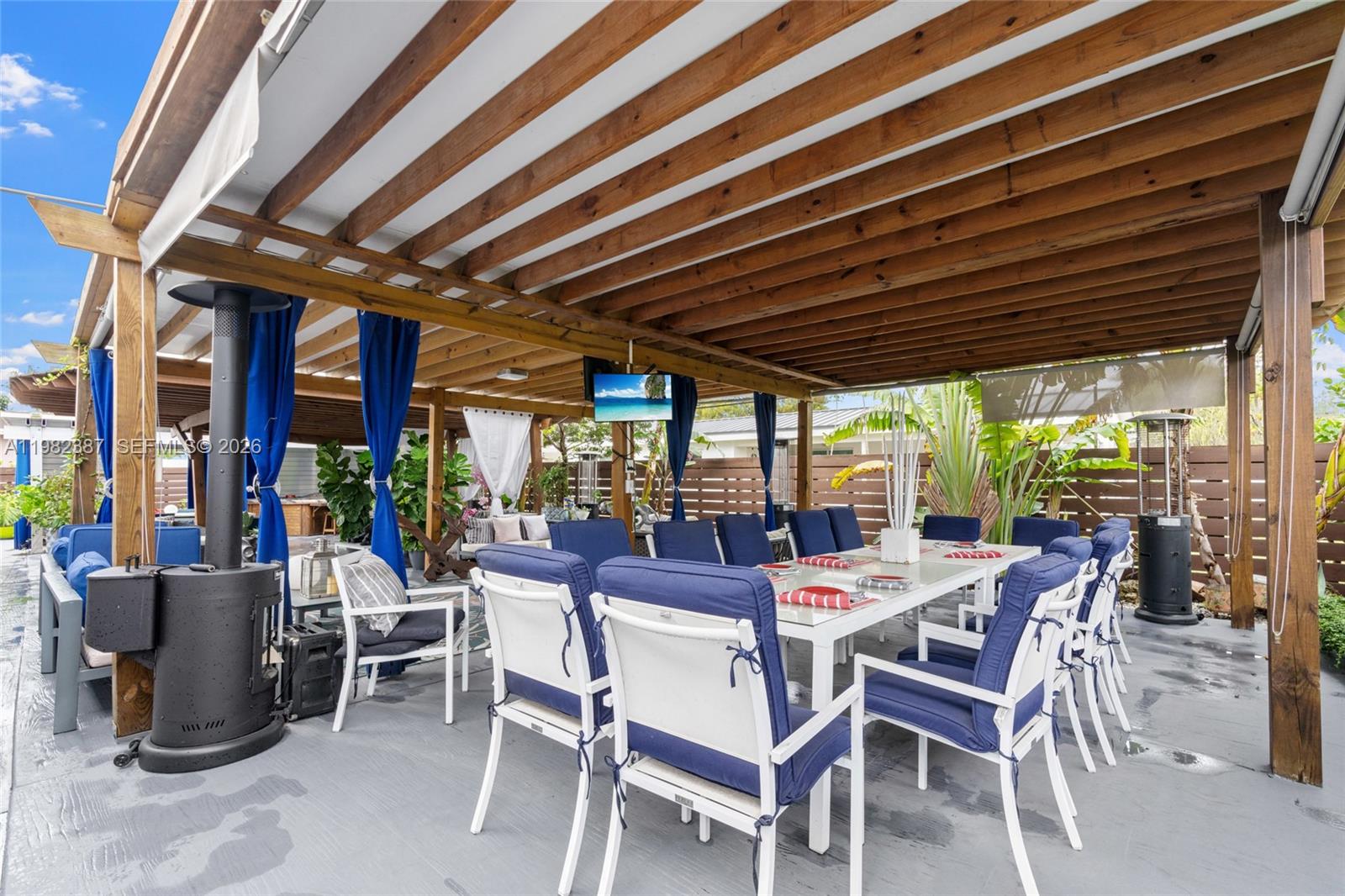 12721 Southwest 47th Street Miami, FL 33175 - Photo 38 of 47 a view of a patio with a table and chairs and a barbeque