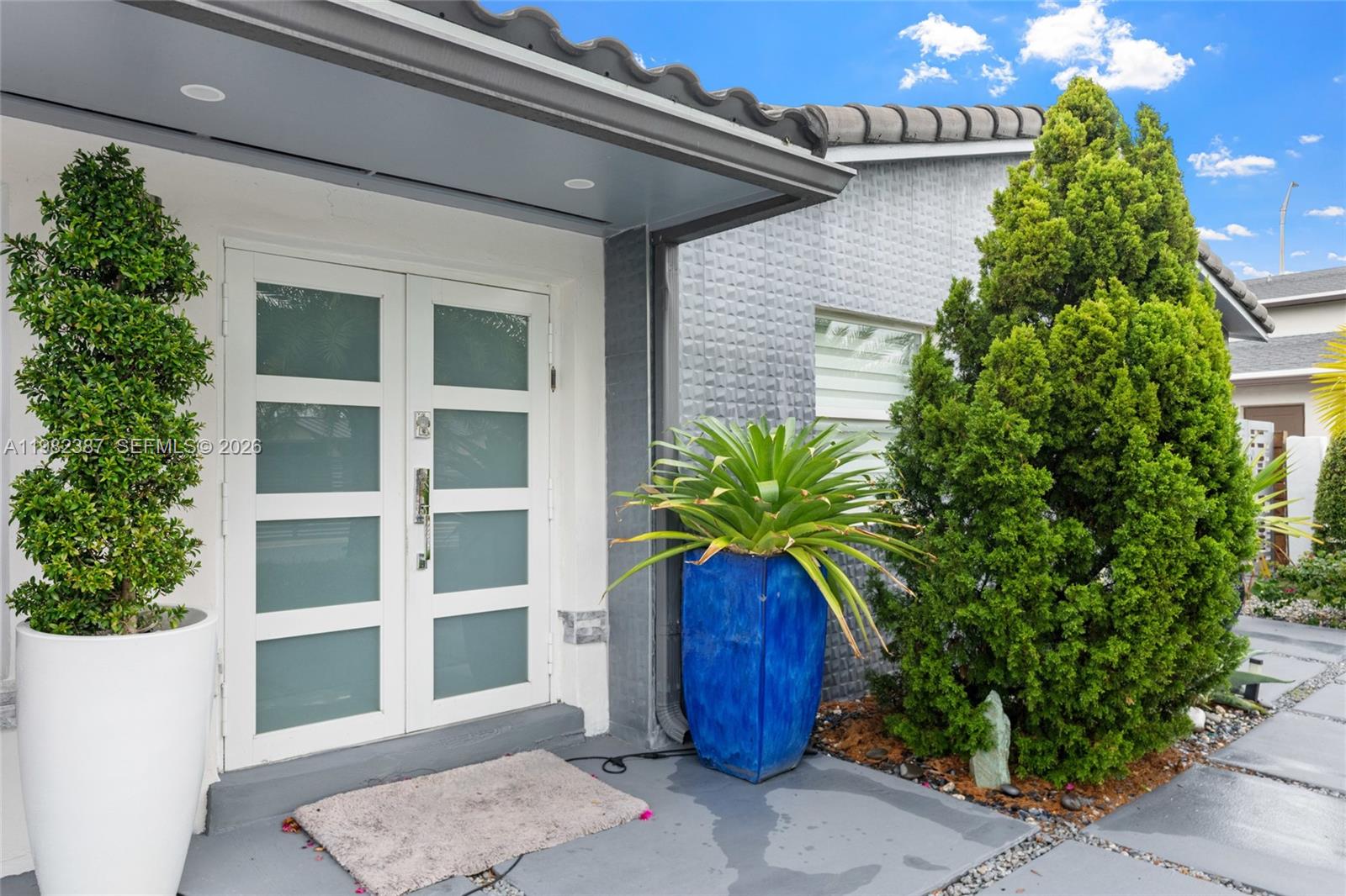 12721 Southwest 47th Street Miami, FL 33175 - Photo 5 of 47 a potted plant in front of a door