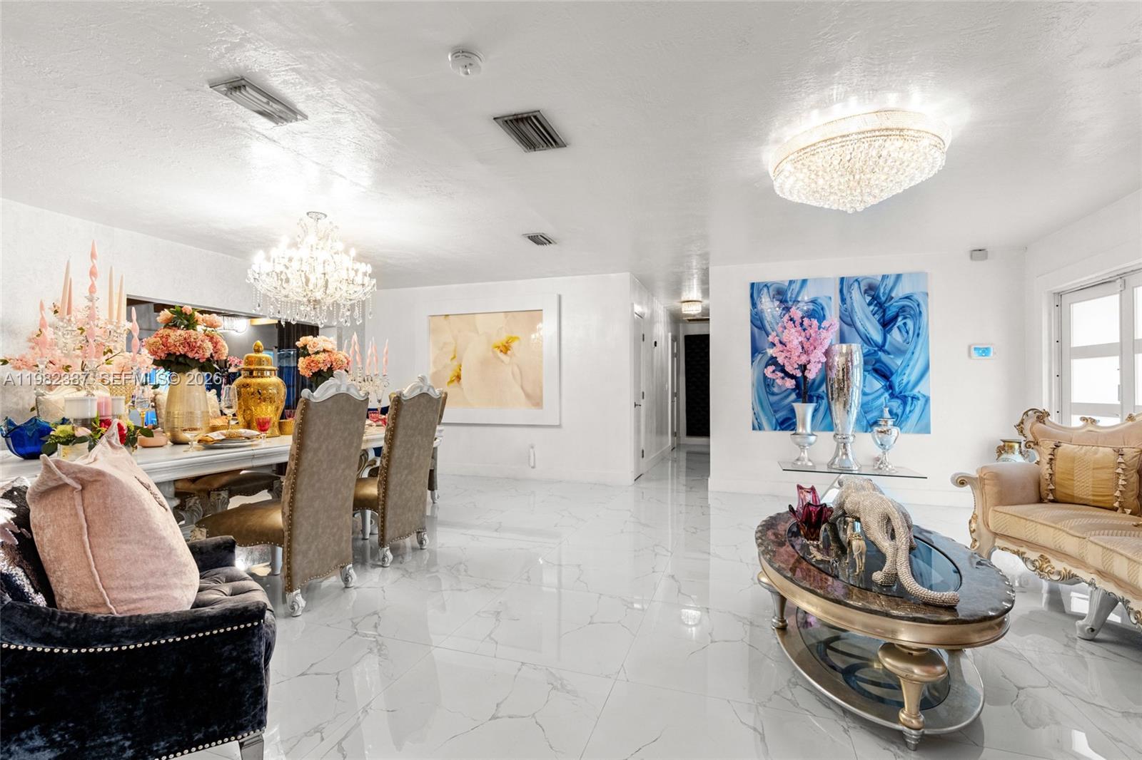 12721 Southwest 47th Street Miami, FL 33175 - Photo 9 of 47 a living room with furniture and a chandelier