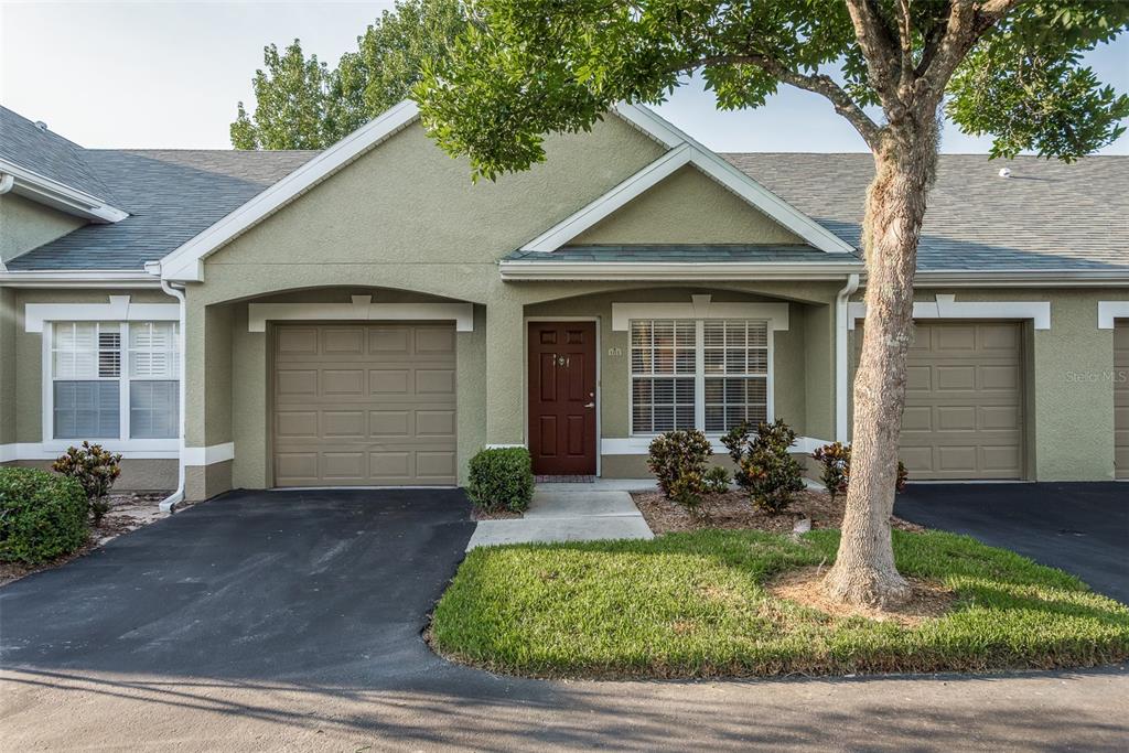 3558 Wembley Way, Unit 103 Palm Harbor, FL 34685 - Photo 1 of 1 a front view of a house with garden