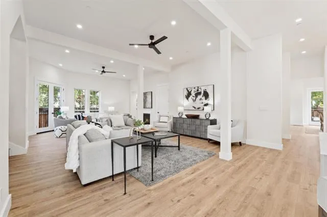 a living room with furniture a potted plant and a fireplace