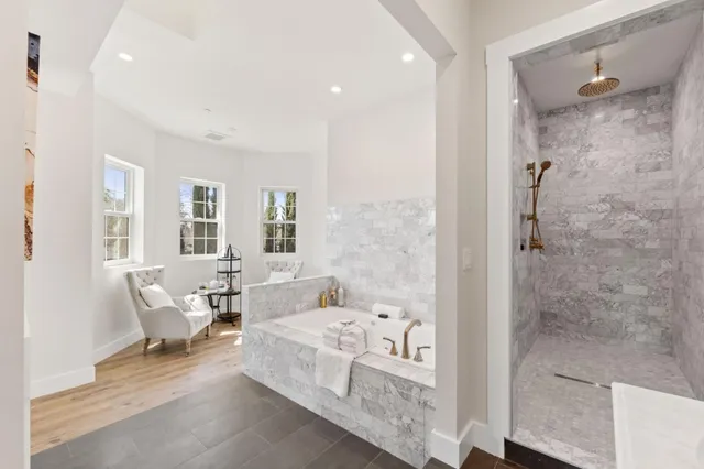 a spacious bedroom with a bed a table and chairs