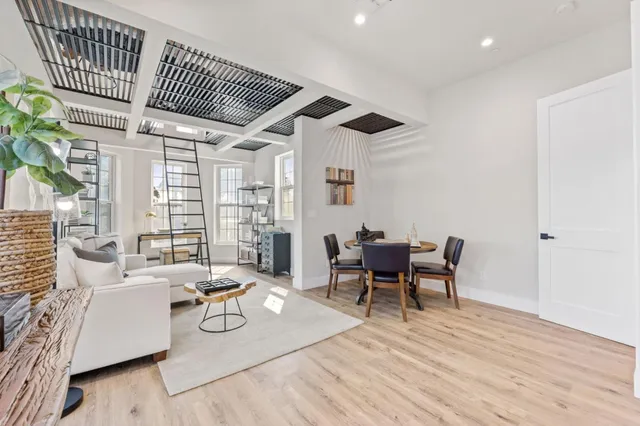 a view of a dining room with furniture window and wooden floor