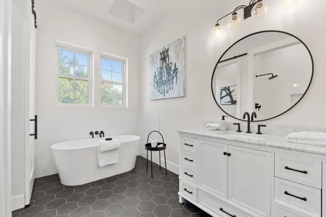 a kitchen with a sink stove and wooden floor