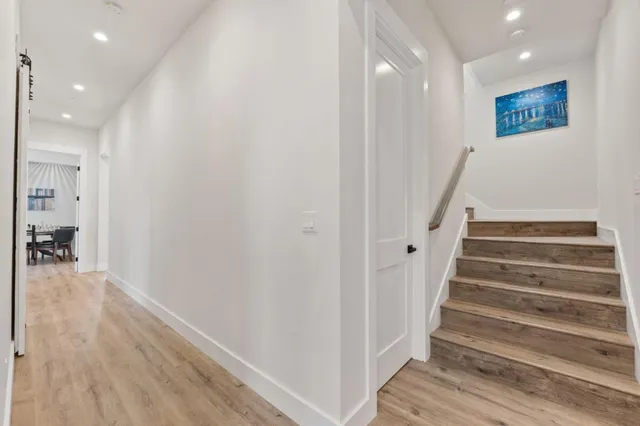 a kitchen with kitchen island white cabinets and refrigerator