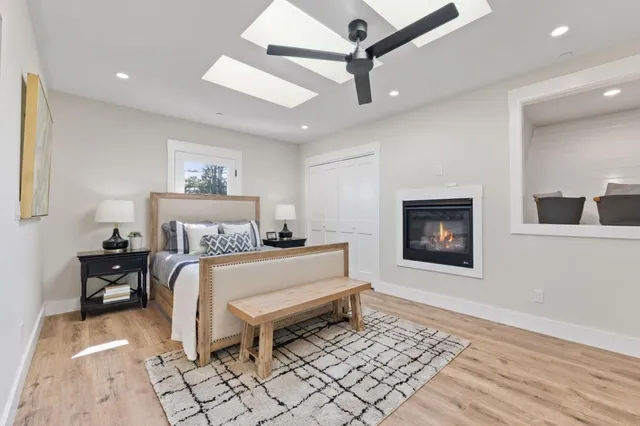 a living room with furniture a large window and a fireplace