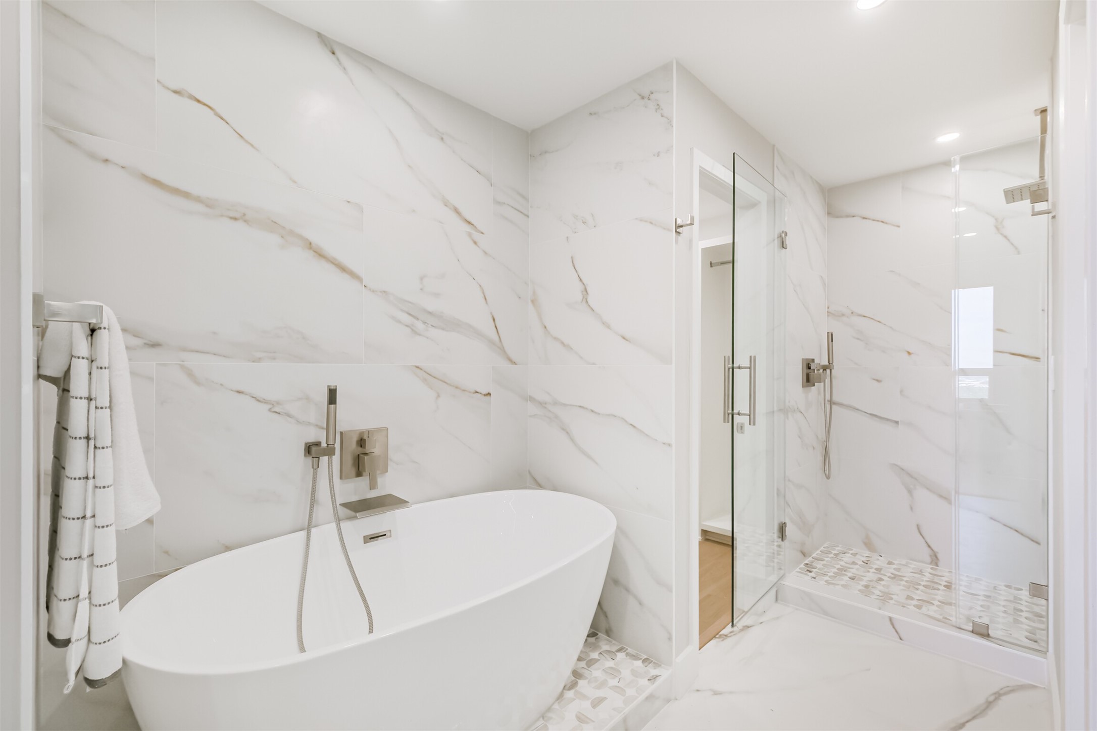a white bath tub sitting in a bathroom and shower