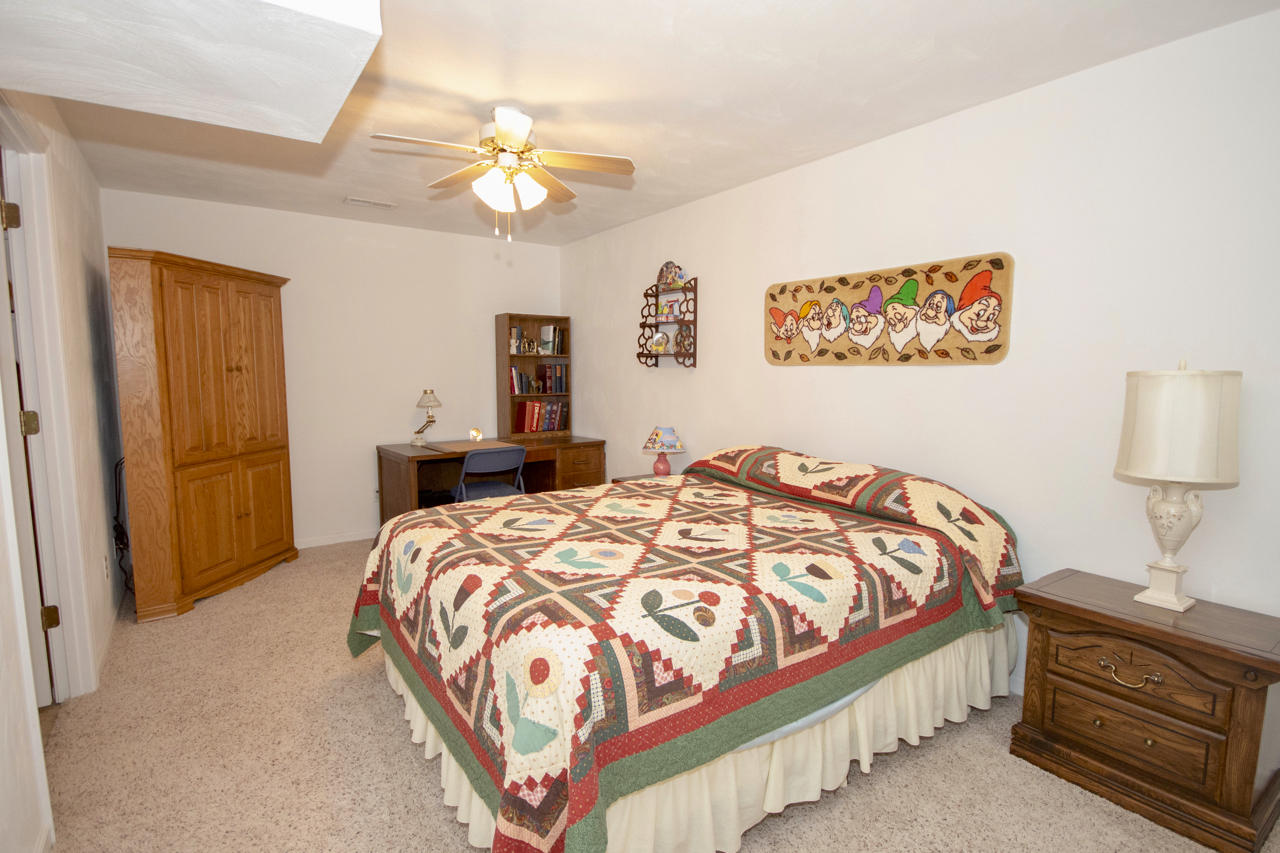 1857 Emmaus Church Road Moneta, VA 24121 - Photo 40 of 42 a bedroom with a bed and a chandelier