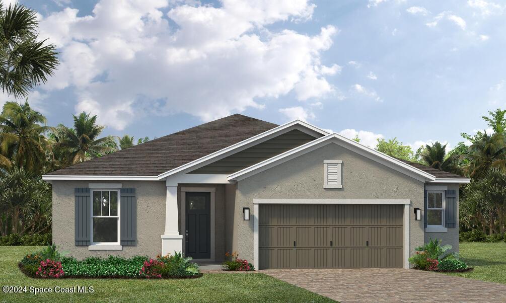 a front view of house with a garden