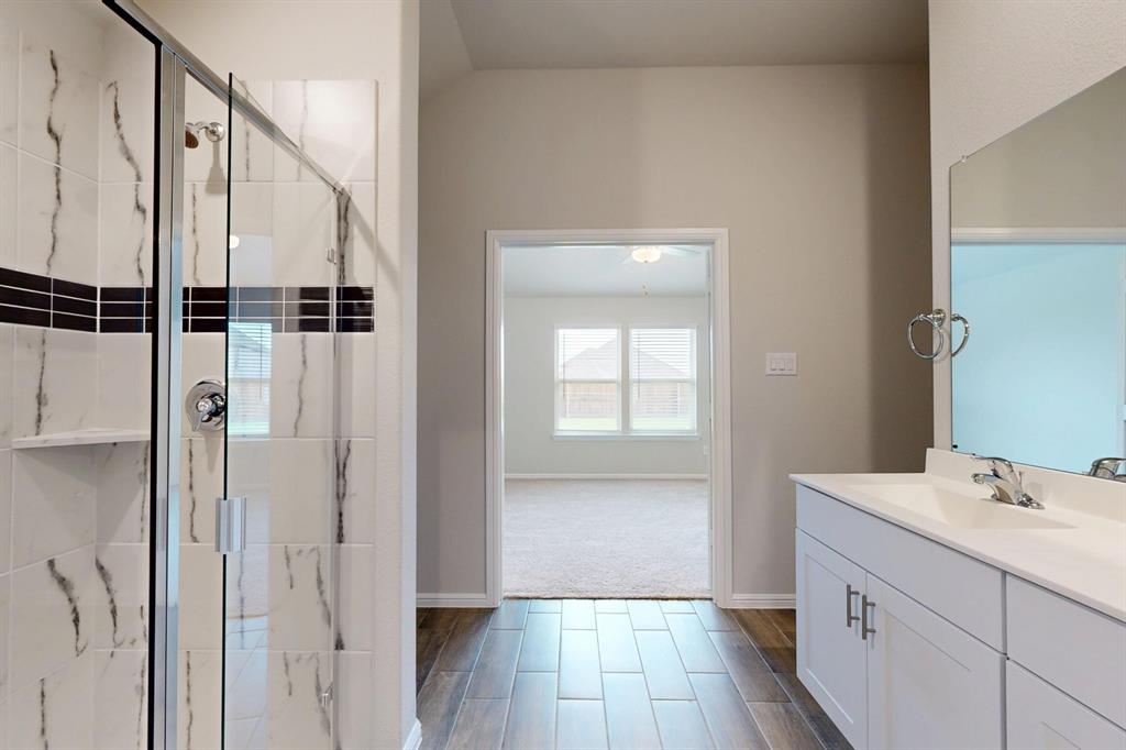 408 Wydown Drive Princeton, TX 75407 - Photo 25 of 40 a bathroom with a sink a mirror and shower
