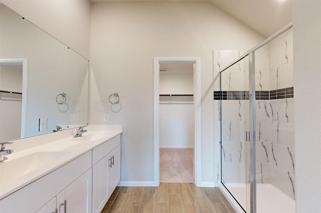 408 Wydown Drive Princeton, TX 75407 - Photo 5 of 40 a bathroom with a double vanity sink a mirror and a shower