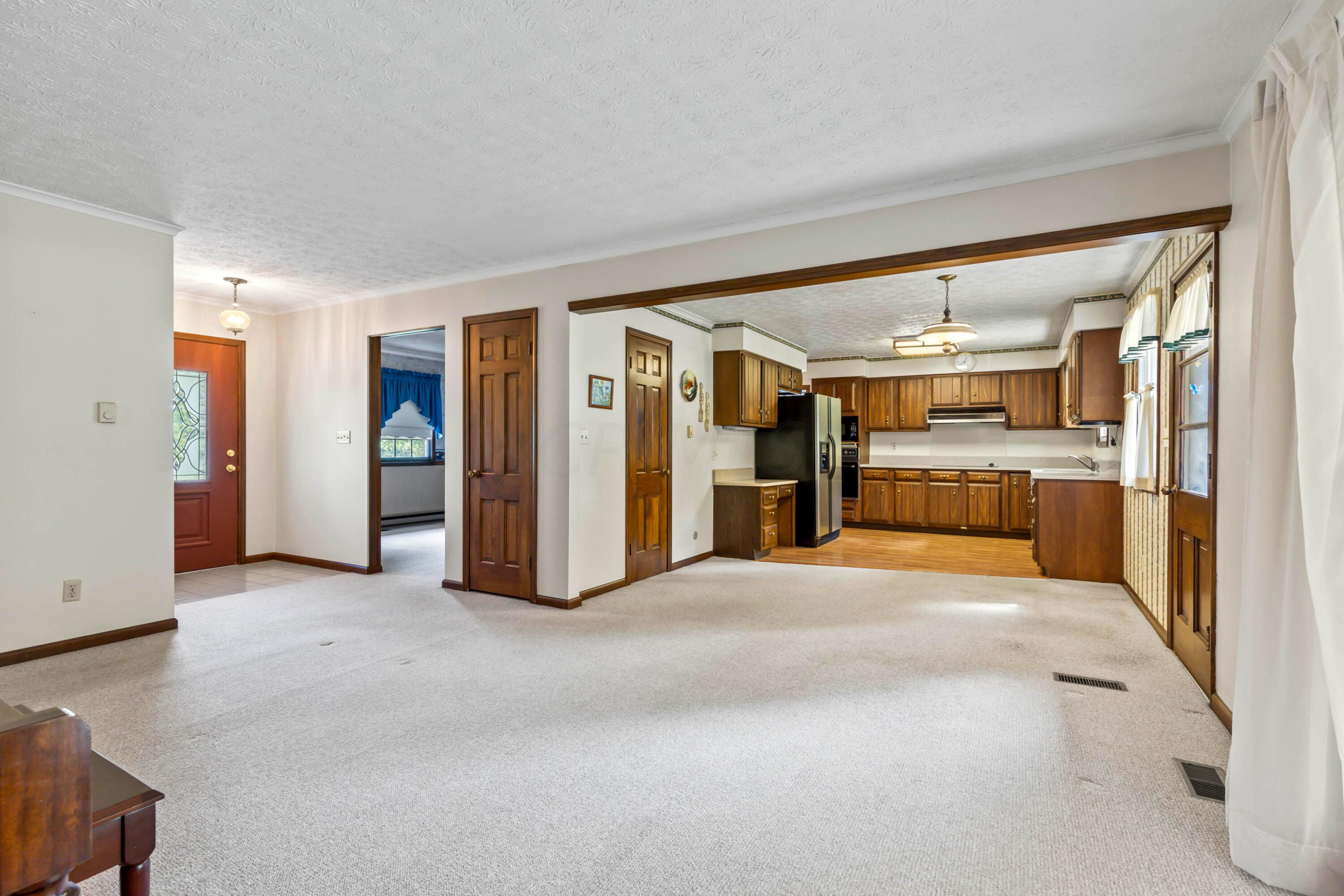 5764 Cheshire Road Galena, OH 43021 - Photo 10 of 59 • Berber carpet
• Tan painted walls
• Coat closet
• Crown molding
• (2) electric baseboard
heaters
• Double sliding doors to
covered deck