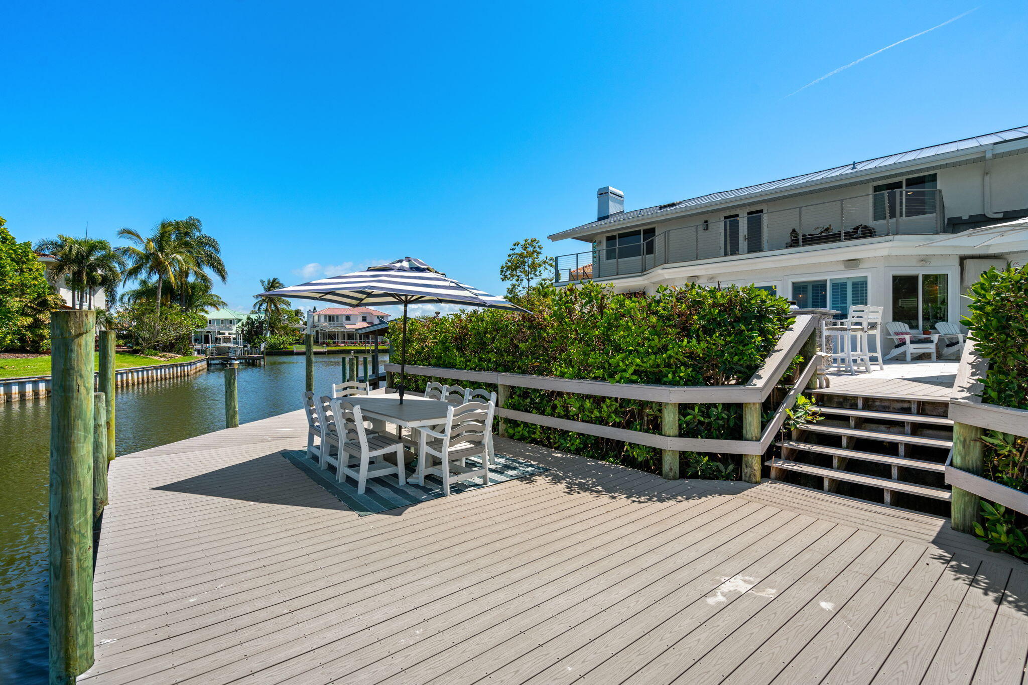 452 Sandy Key Melbourne Beach, FL 32951 - Photo 114 of 140 a view of a roof deck with table and chairs wooden floor and plants