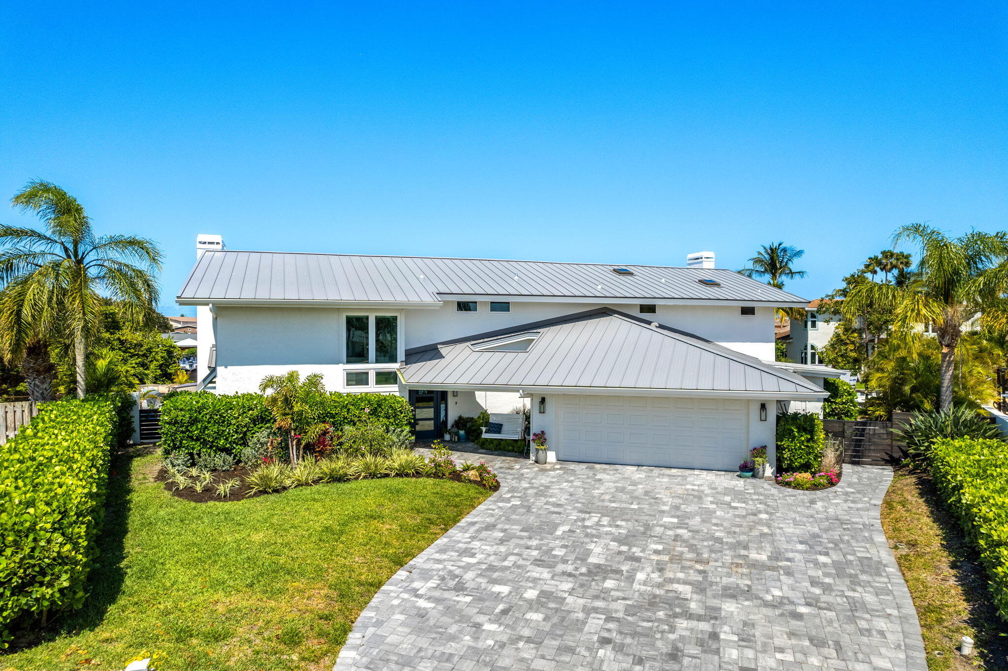452 Sandy Key Melbourne Beach, FL 32951 - Photo 124 of 140 a front view of a house with a yard and garage