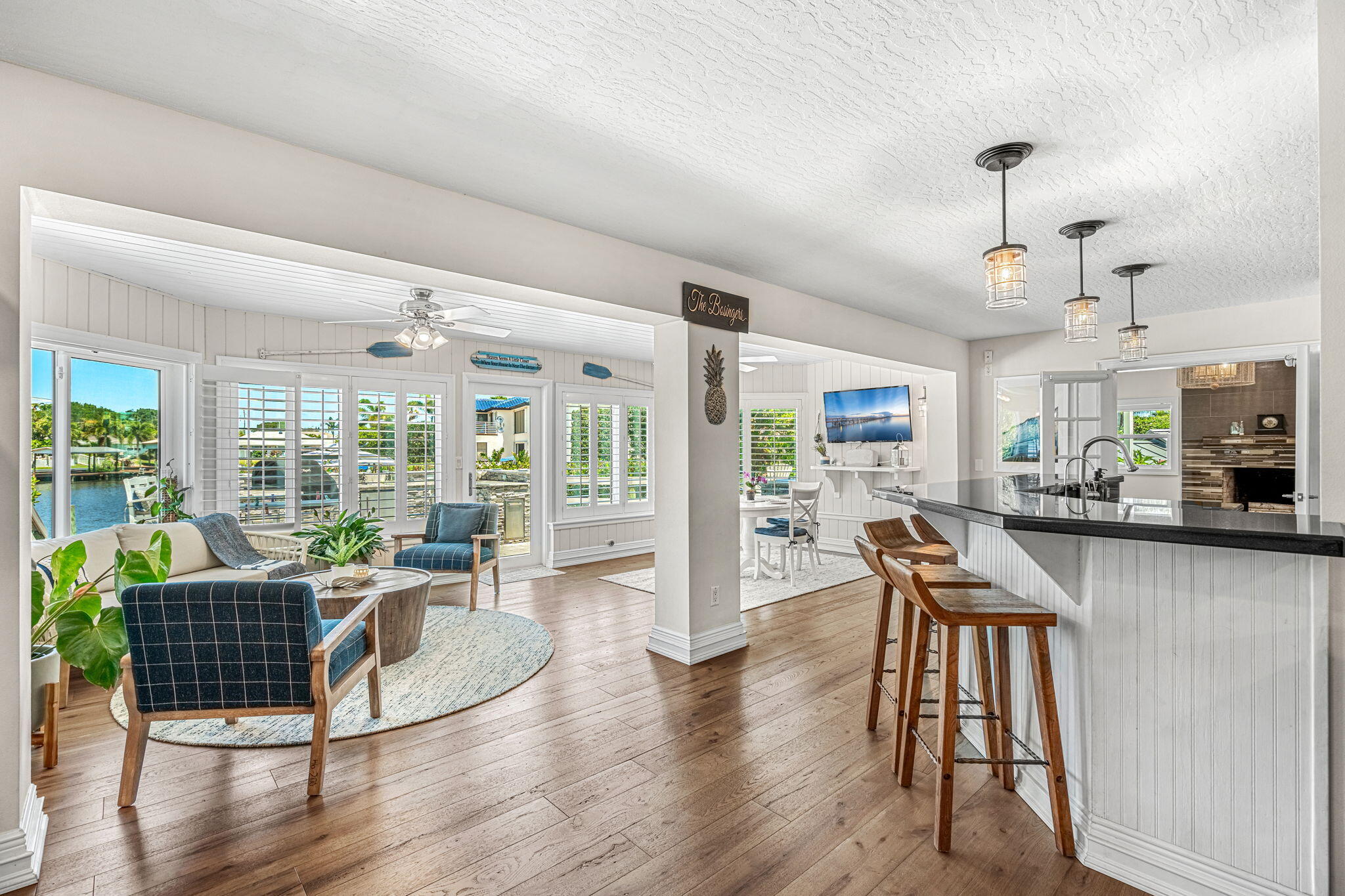 452 Sandy Key Melbourne Beach, FL 32951 - Photo 29 of 140 a dining room with wooden floor a chandelier a glass table and chairs