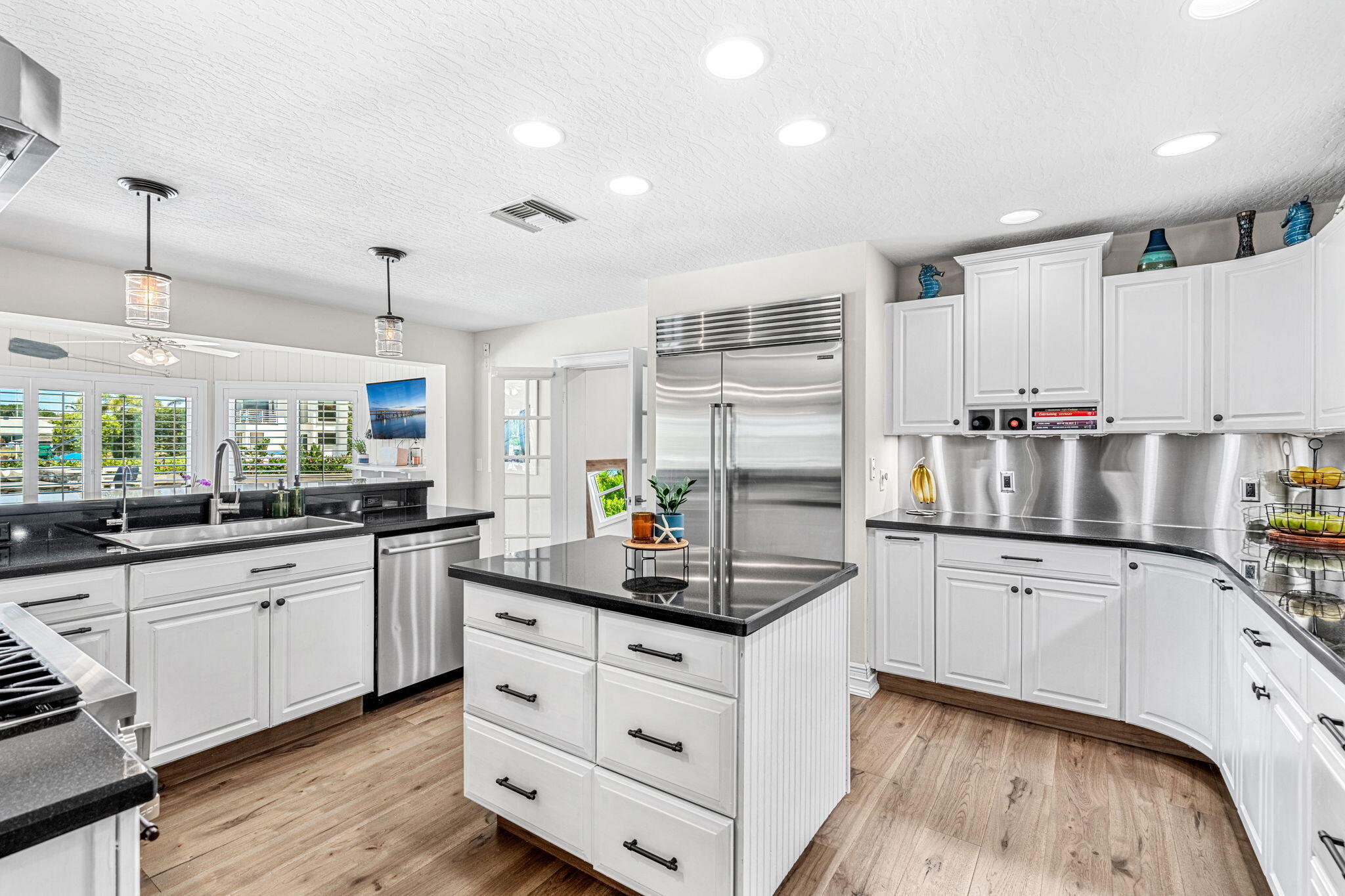 452 Sandy Key Melbourne Beach, FL 32951 - Photo 41 of 140 a kitchen with granite countertop white cabinets and white appliances
