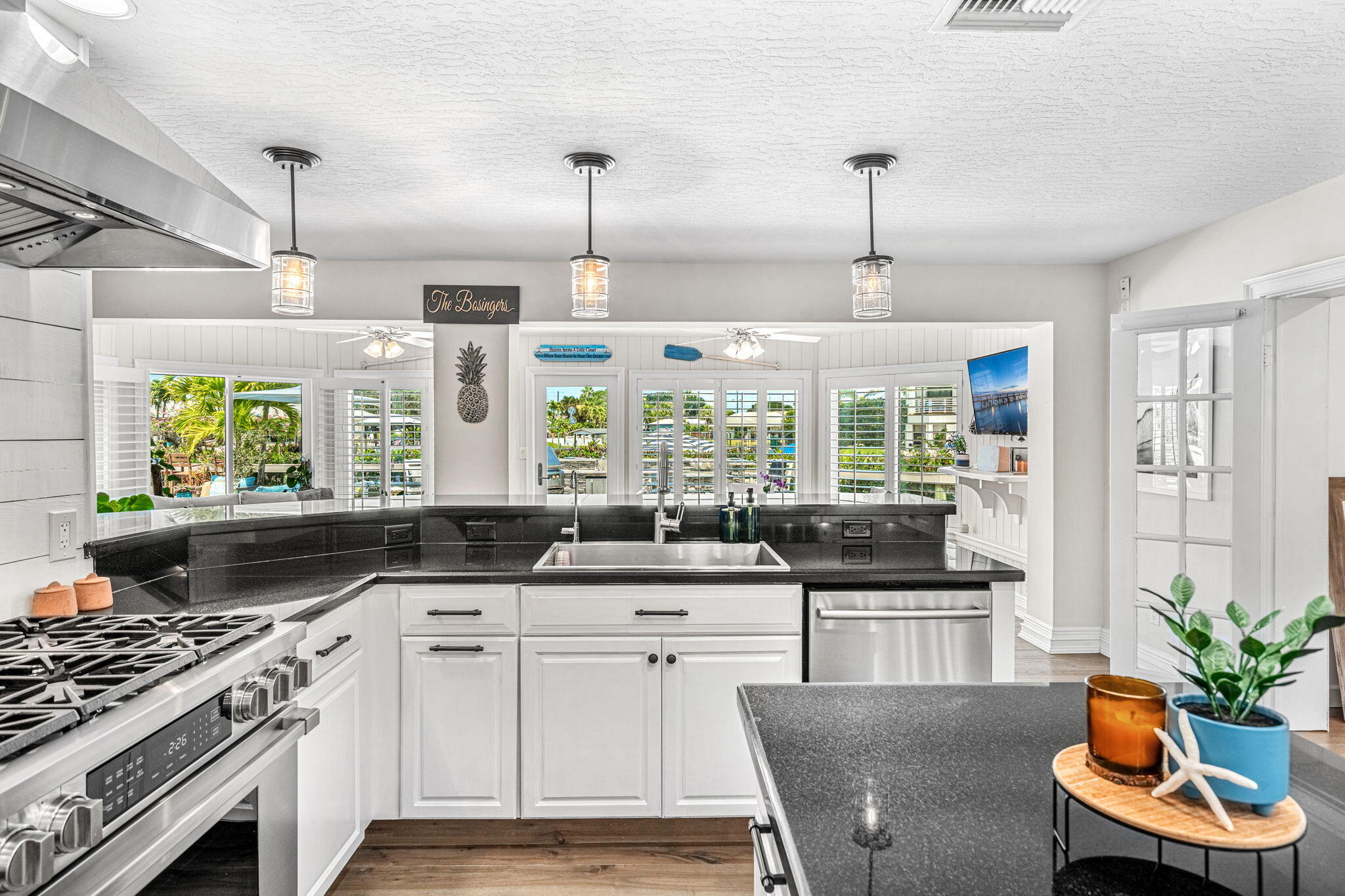 452 Sandy Key Melbourne Beach, FL 32951 - Photo 47 of 140 a kitchen with stainless steel appliances a stove a sink a counter space and a window