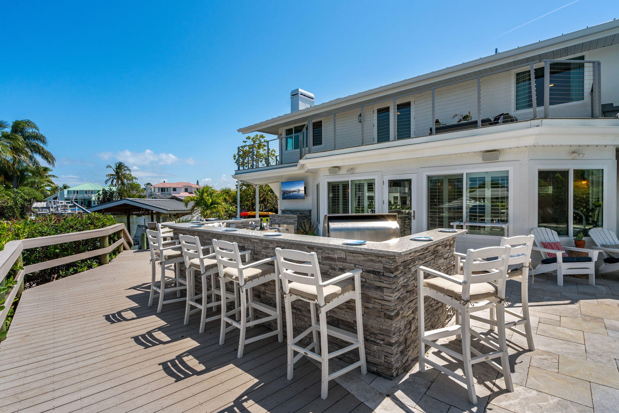 452 Sandy Key Melbourne Beach, FL 32951 - Photo 98 of 140 a view of a patio with table and chairs and potted plants