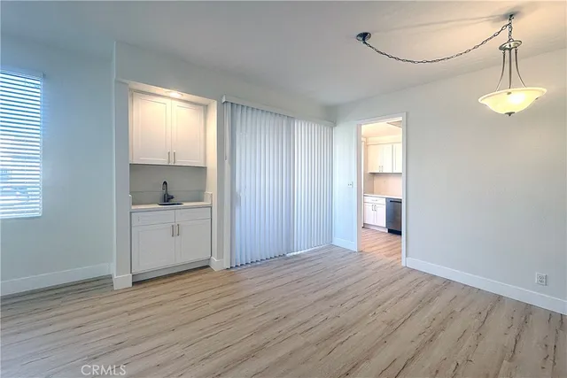 a view of a kitchen with wooden floor and a sink
